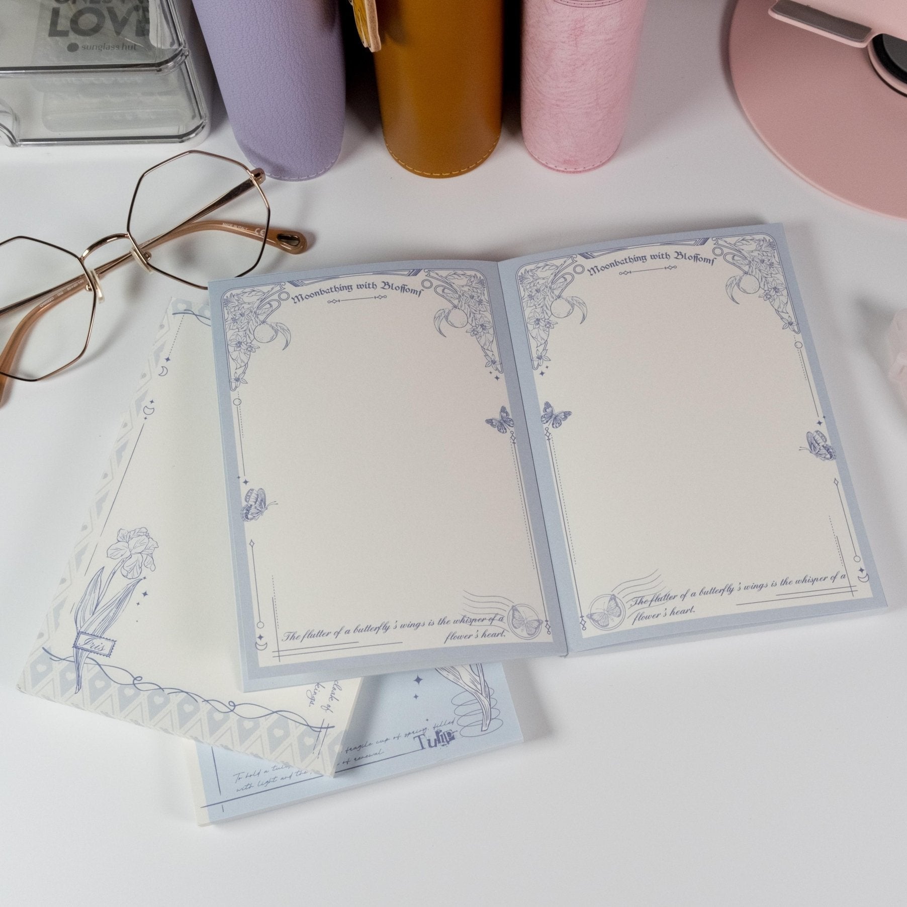 Butterfly and Flower A6 Notepad by Shuhui with hand-drawn blue floral cover design - Miouva