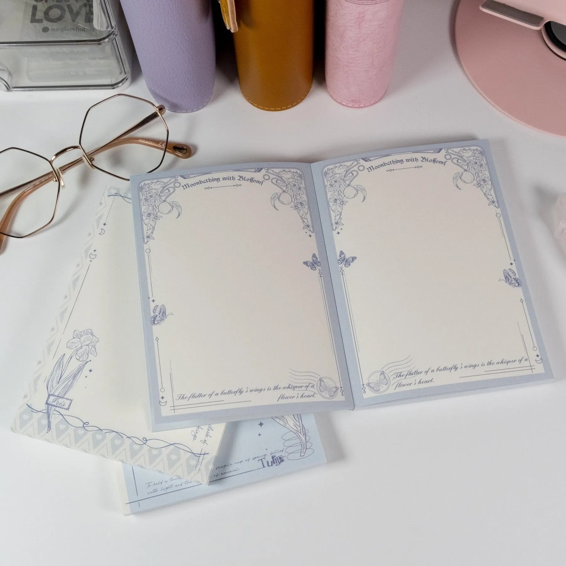 Butterfly and Flower A6 Notepad by Shuhui with hand-drawn blue floral cover design - Miouva