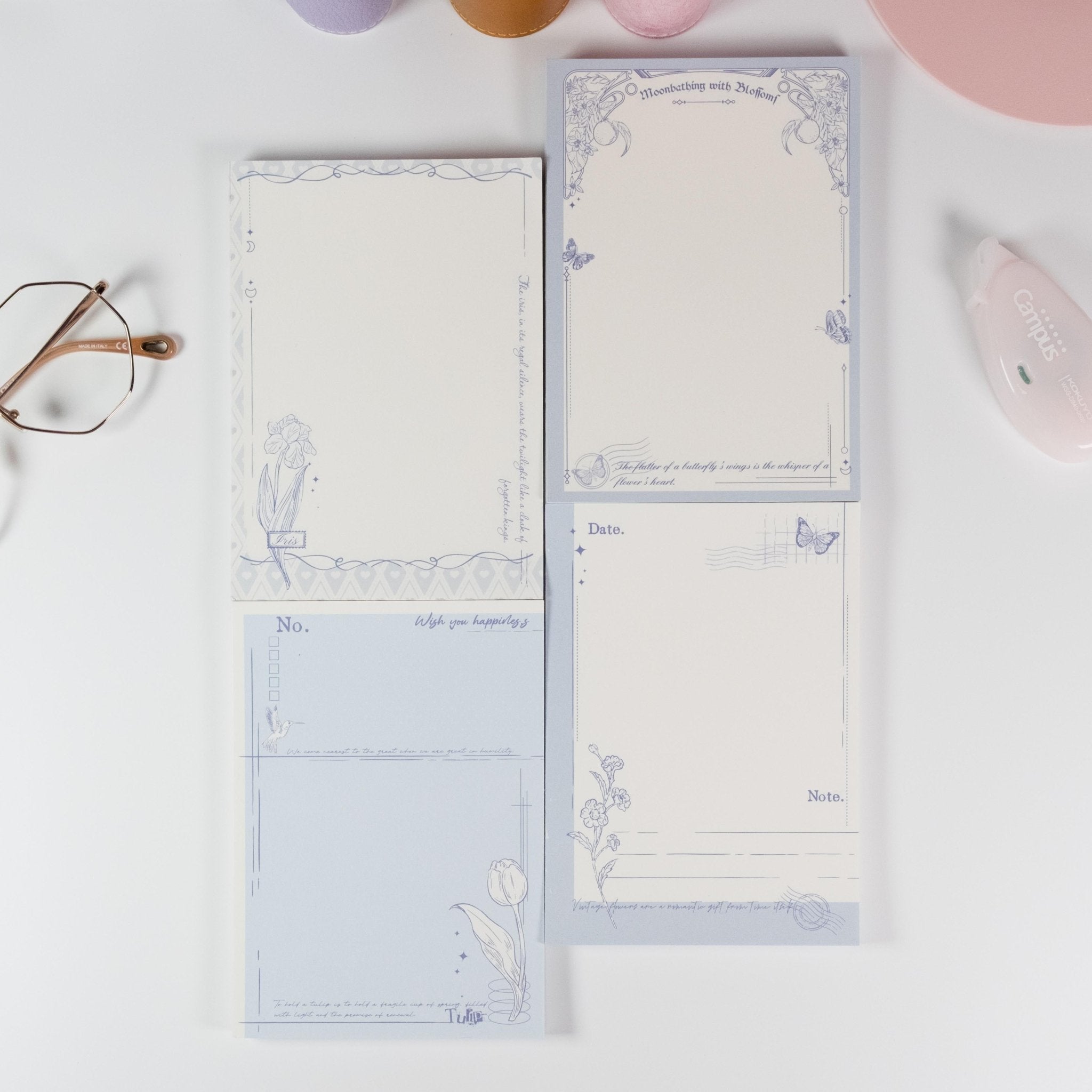 Flat lay of all four Butterfly and Flower A6 notepad designs with postage and butterfly motifs - Miouva