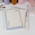 Butterfly and Flower A6 notepad placed on desk with pen and soft lighting - Miouva