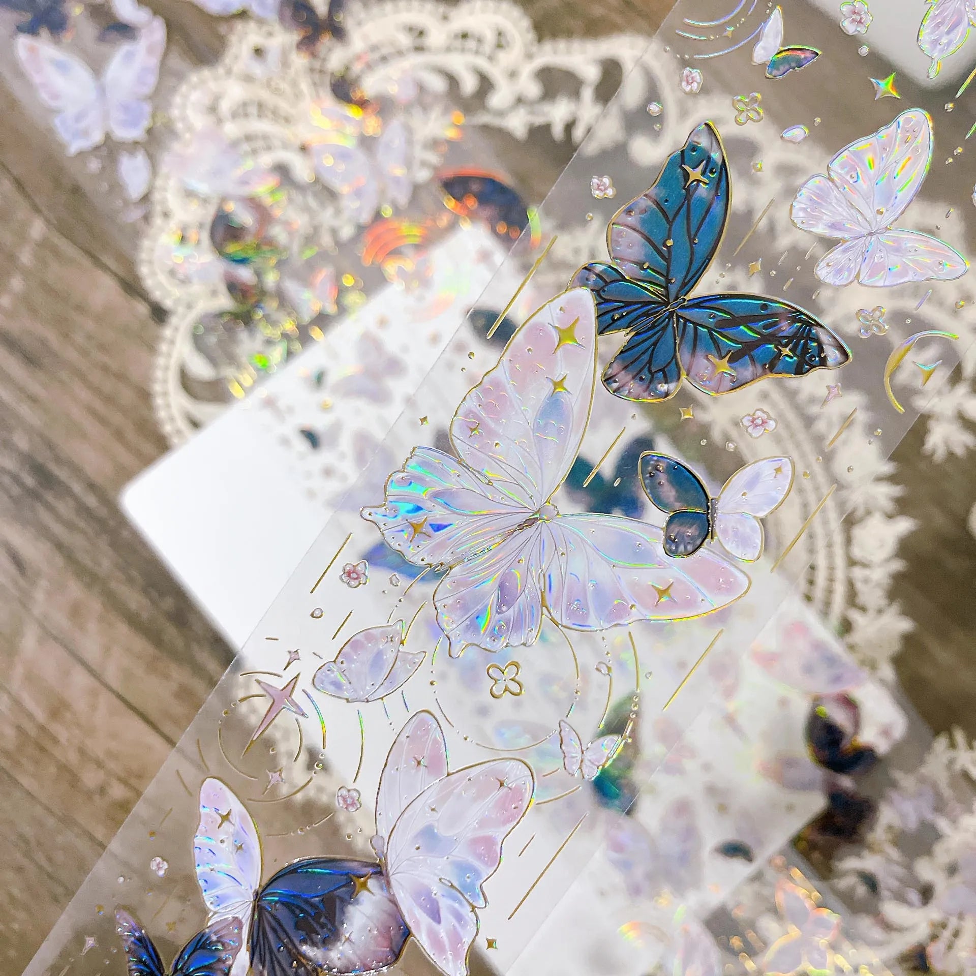 Detailed view of Butterfly Bloom PET Tape showing shimmering butterfly wings and golden stars under light - Miouva
