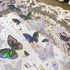 Close-up of iridescent butterfly designs with soft pink and blue reflections on transparent PET tape - Miouva