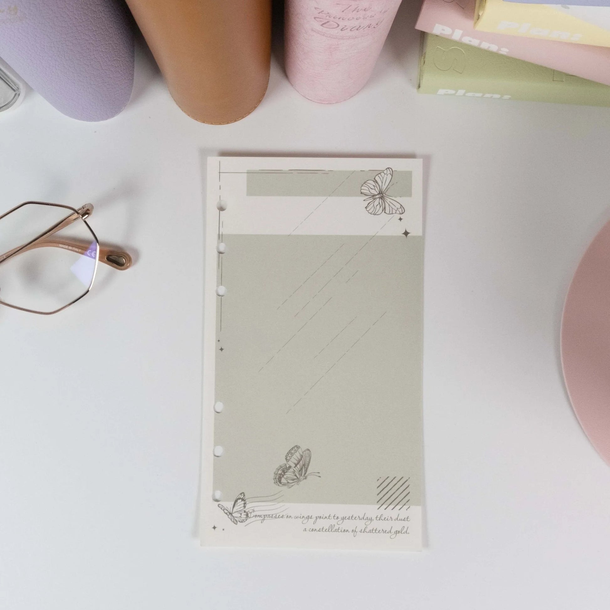 Close-up of punched planner refill with butterfly stamp artwork - Miouva