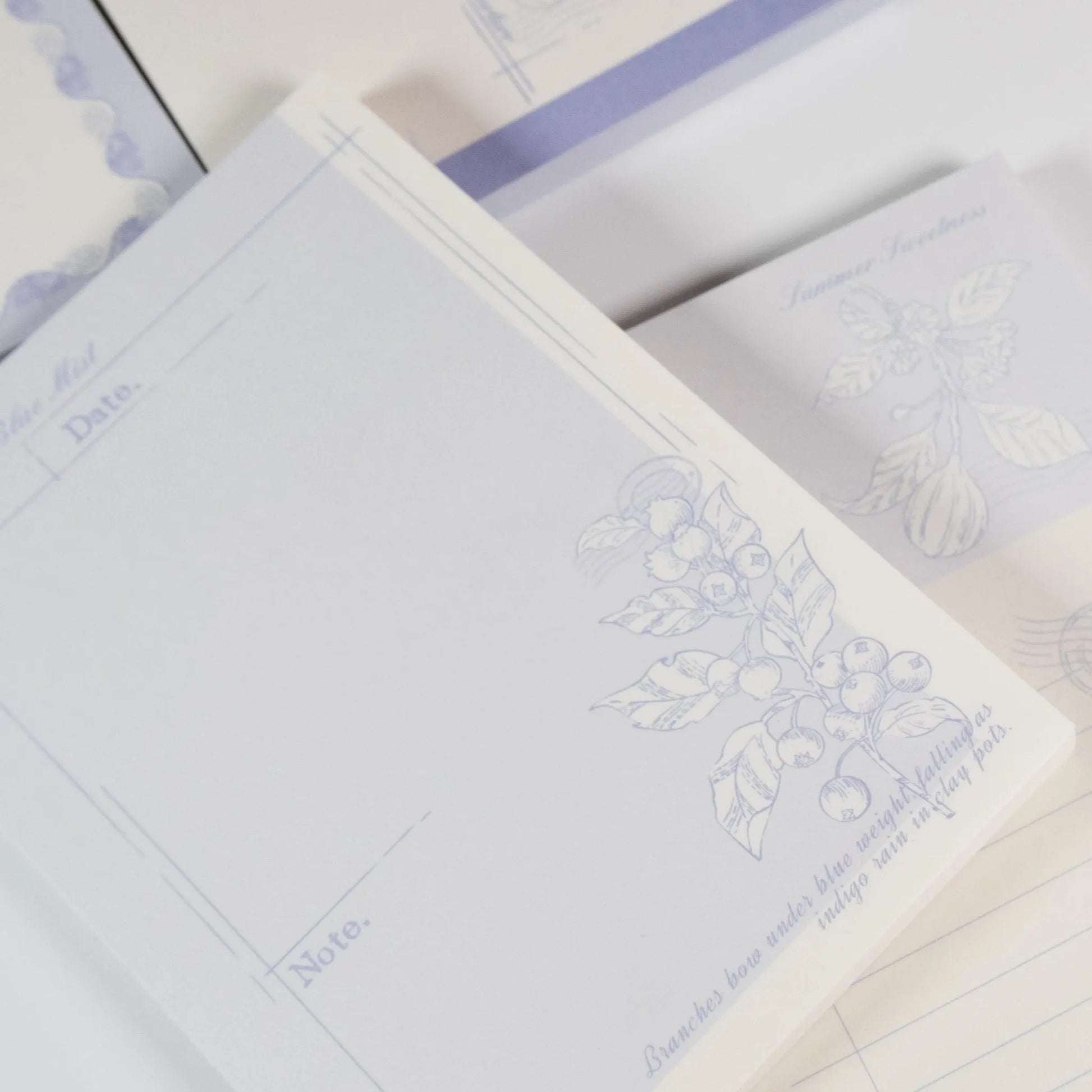 Close-up of Floral Fruits A6 notepad showing purple botanical details and paper texture - Miouva