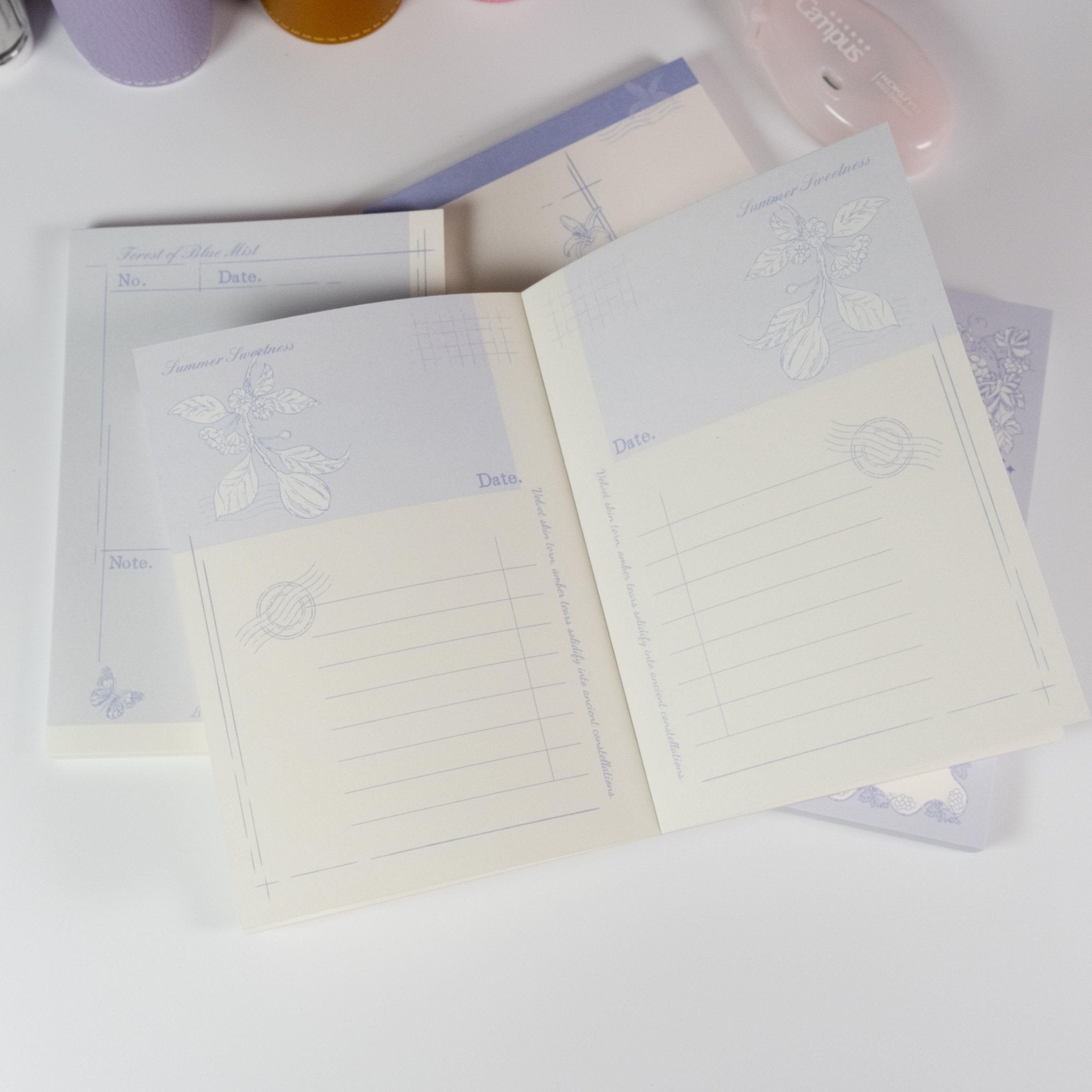 Floral Fruits A6 Notepad by Shuhui with hand-drawn purple floral and fruit cover design - Miouva