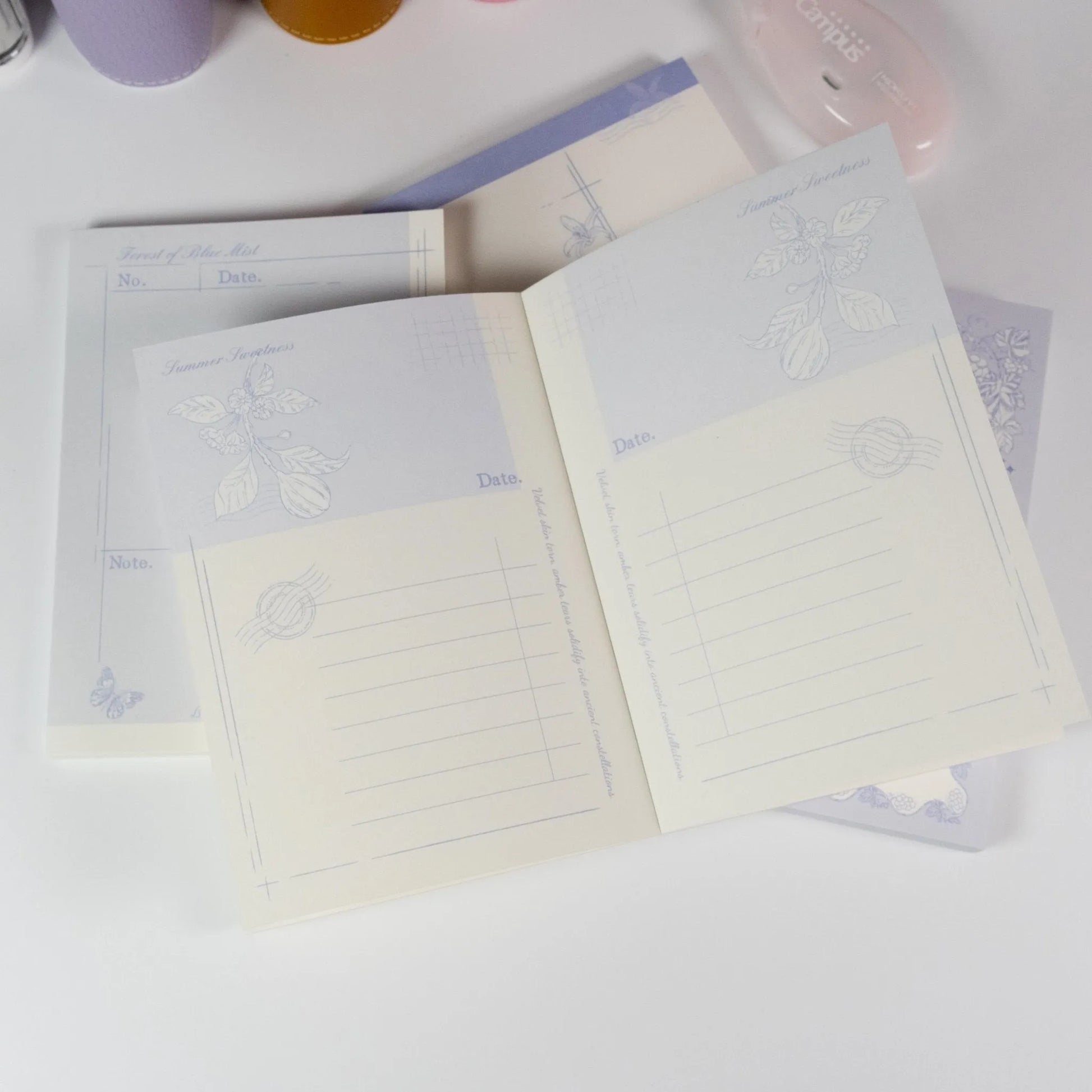 Floral Fruits A6 Notepad by Shuhui with hand-drawn purple floral and fruit cover design - Miouva