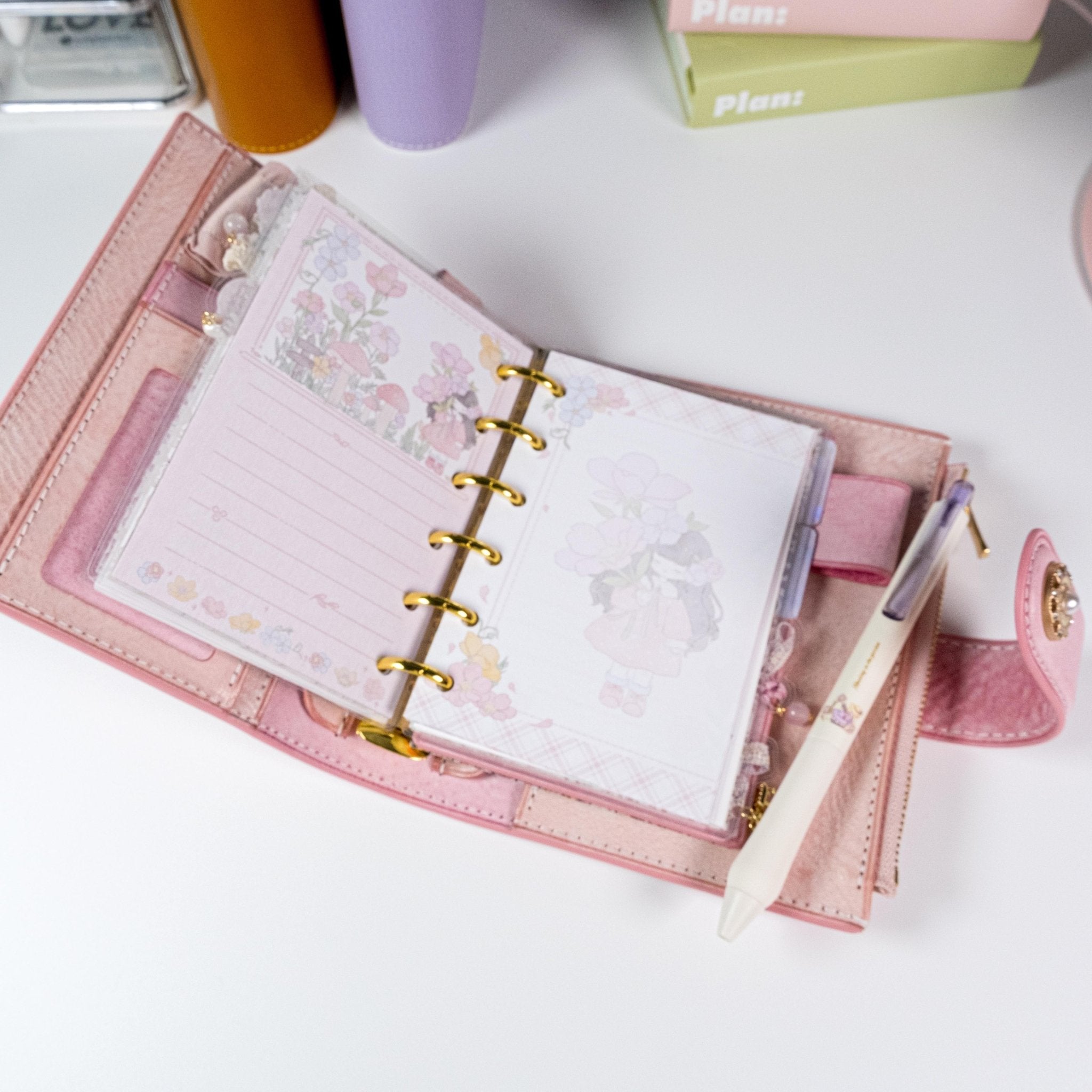 Pink Primrose planner refills displayed inside a pocket-size binder, showing floral layout and journaling use - Miouva