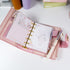 Pink Primrose planner refills displayed inside a pocket-size binder, showing floral layout and journaling use - Miouva