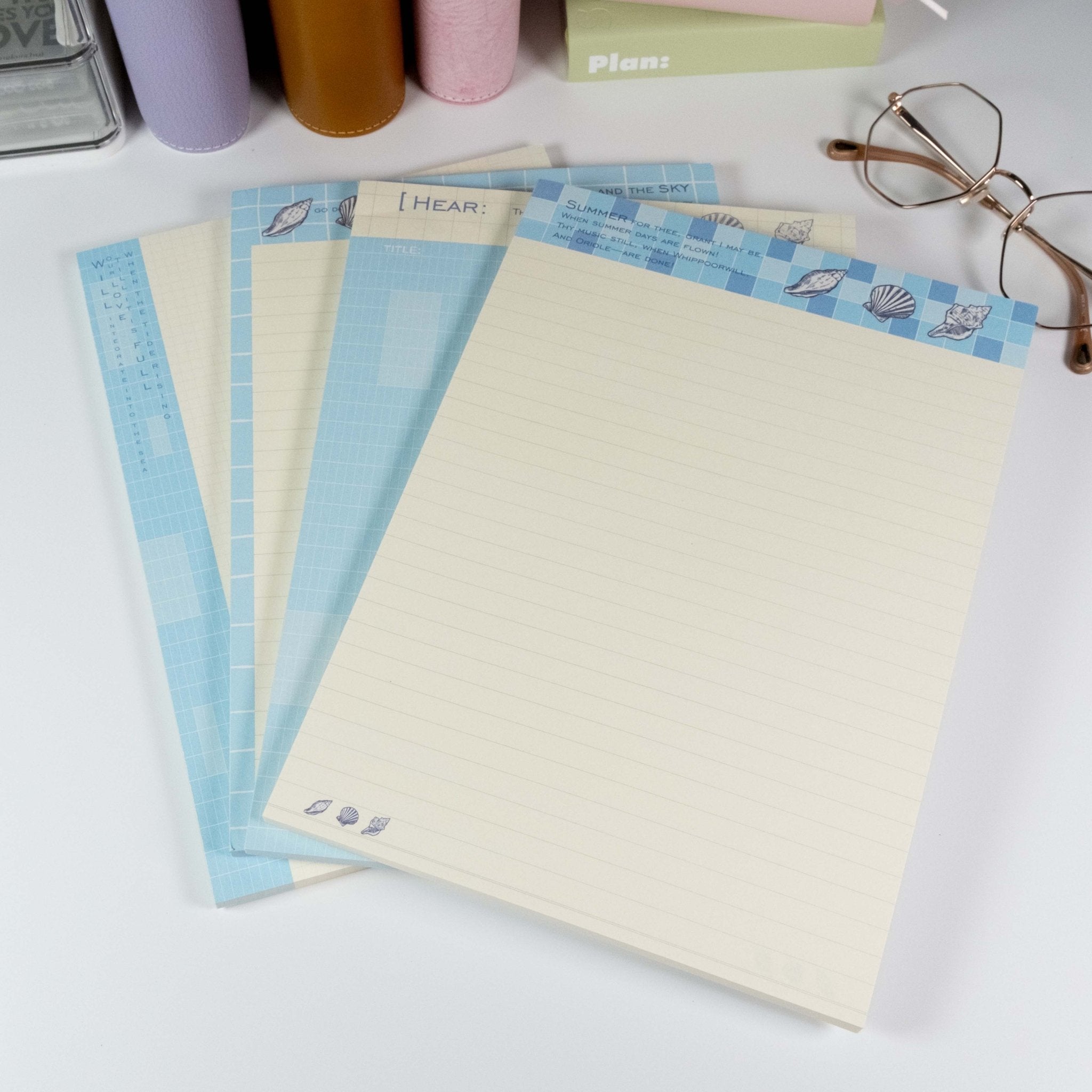 Summer Beach B5 notepads by Shuhui with blue and cream pages on a white desk - Miouva