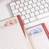 Close-up of Vintage Train Notepad highlighting hand-drawn postage marks, textured paper, and fine ink details - Miouva
