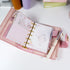 Pink Primrose planner refills displayed inside a pocket-size binder, showing floral layout and journaling use - Miouva