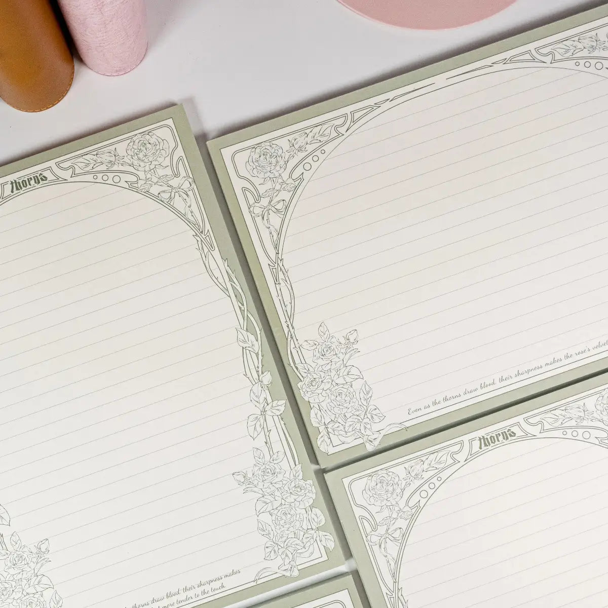 Flat-lay of Thorn Rose B5 notepad showing elegant lined pages - Miouva